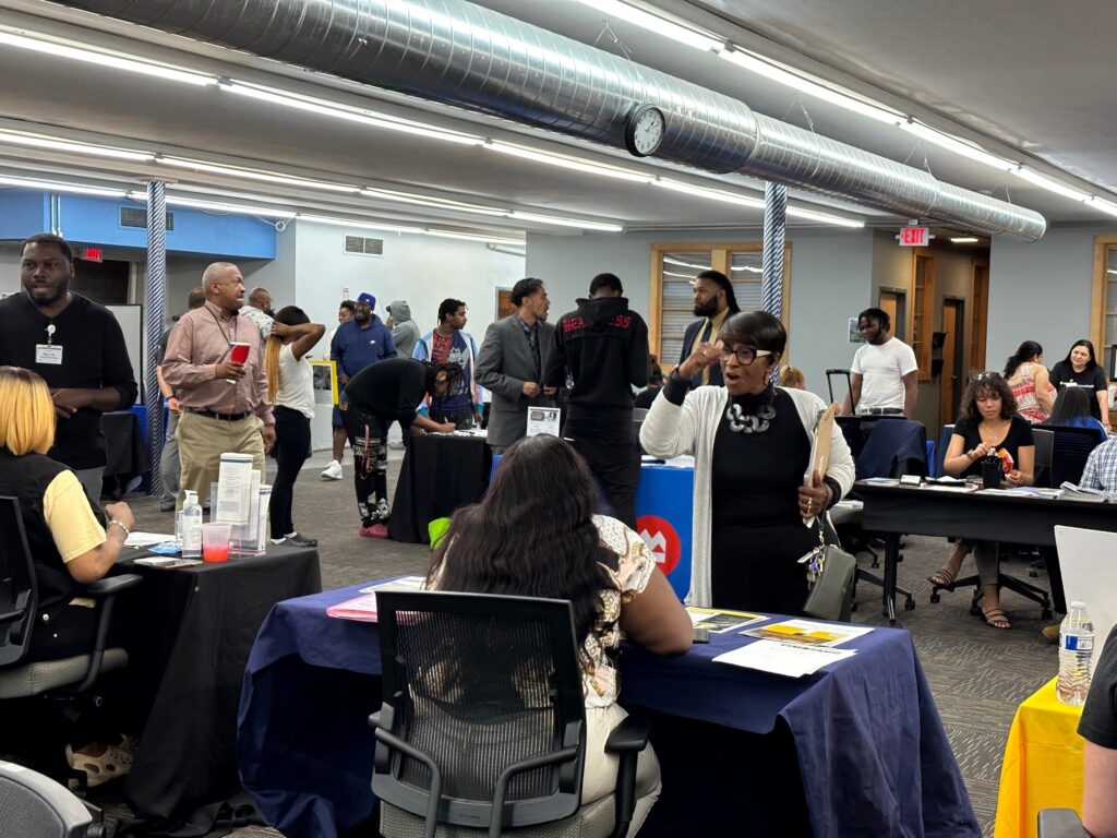 people talking and sharing information at resource fair